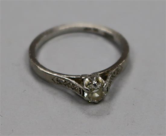 An 18ct white gold and platinum single stone diamond ring, with diamond set shoulders, size P.